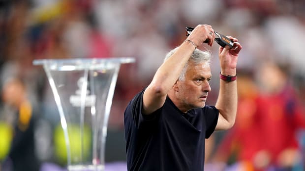 Roma manager Jose Mourinho pictured removing his silver medal after his team lost to Sevilla in the 2023 UEFA Europa League final
